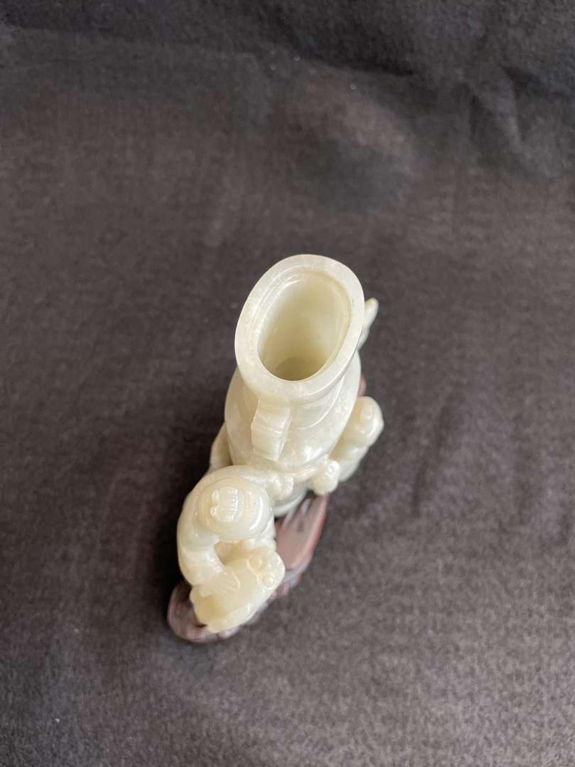 A Chinese jade "Boys, Kylin and Phoenix" vase on carved wood stand 玉雕童子凤鸟花樽及底座