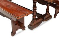 An English Baroque Style Walnut Trestle Table and a Pair of Associated Benches