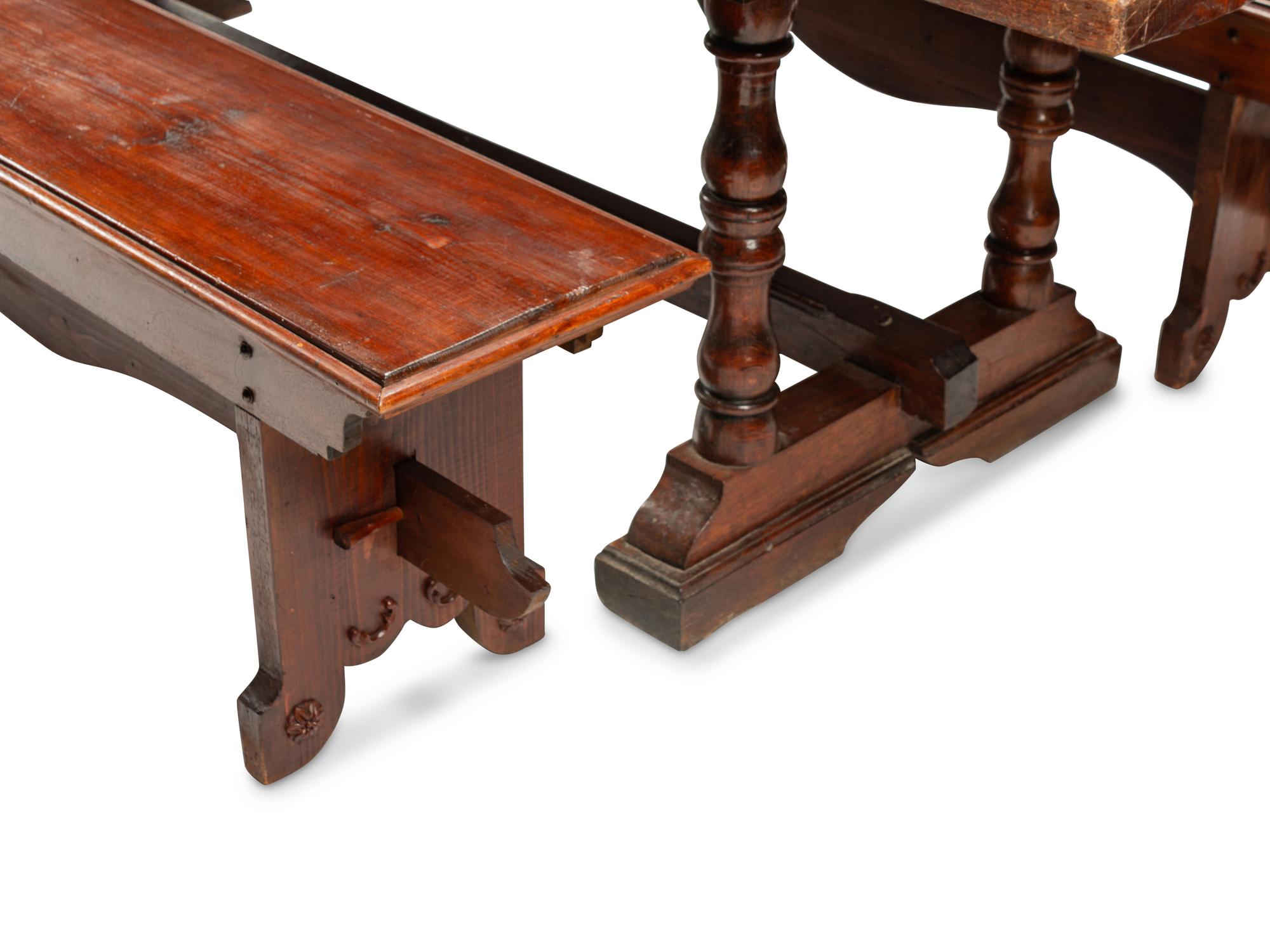 An English Baroque Style Walnut Trestle Table and a Pair of Associated Benches