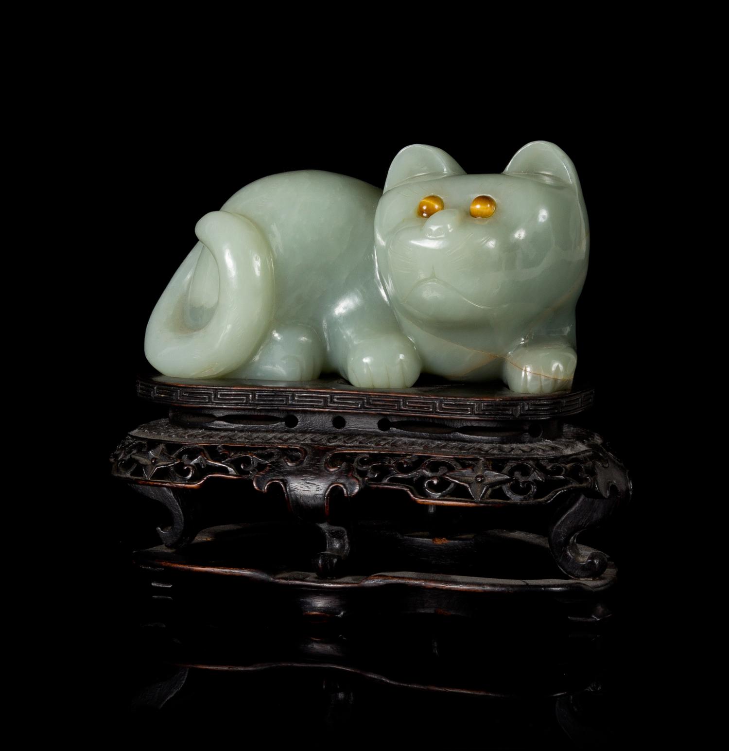 A Carved Celadon Jade Figure of a Cat Length 6 inches.