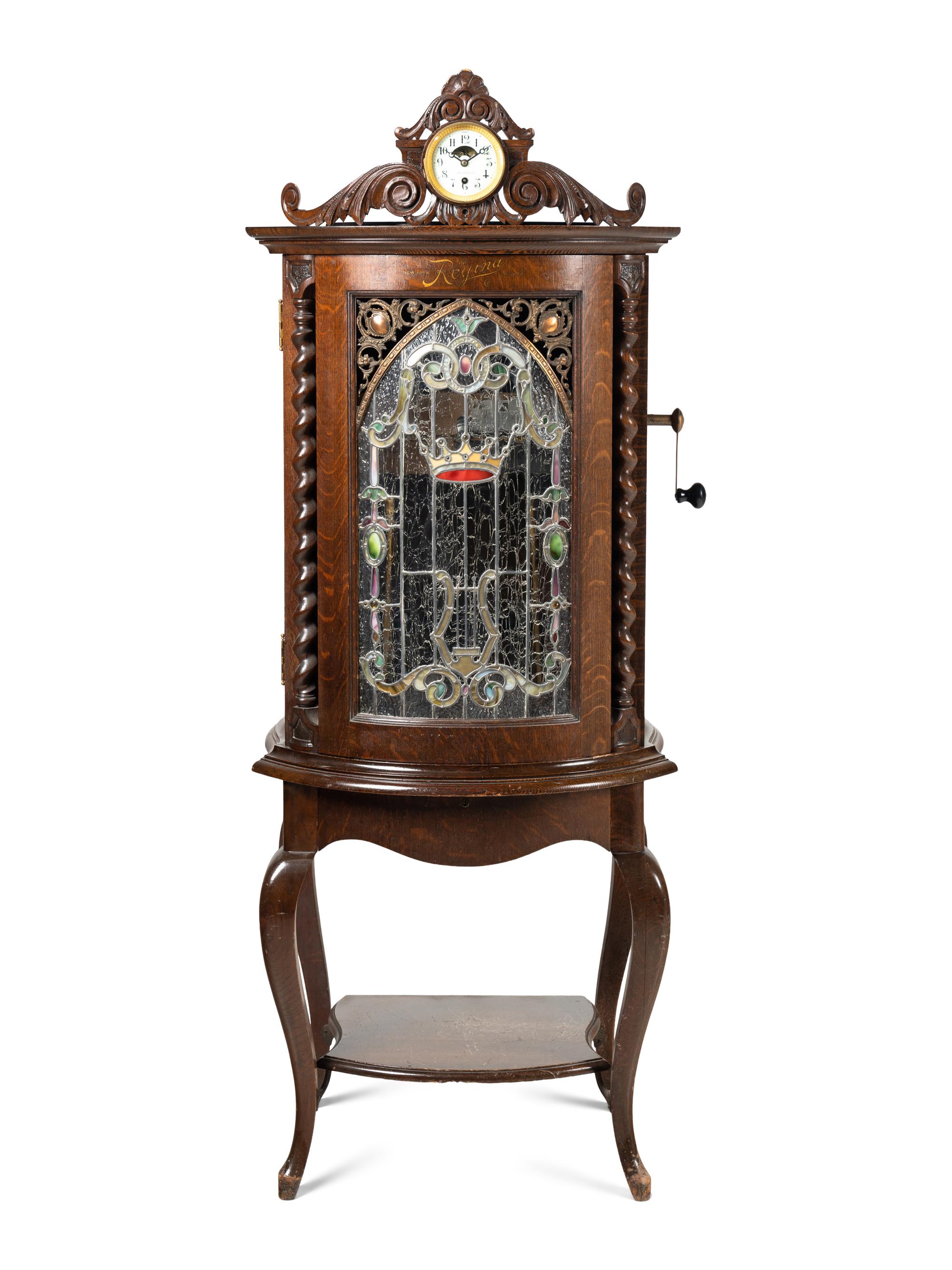 A Regina Corona 15 1/2 Inch Disk Change Music Box with Clock
