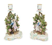 A Pair of Meissen Porcelain Figural Candlesticks with Floral Arbors