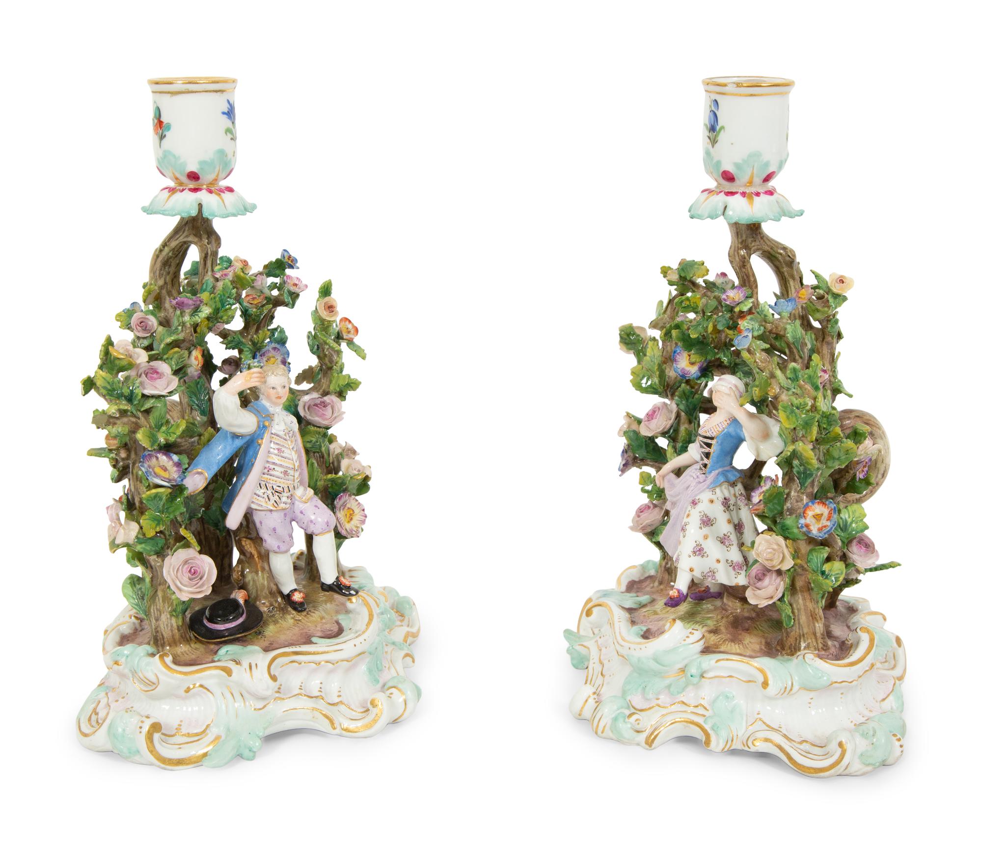 A Pair of Meissen Porcelain Figural Candlesticks with Floral Arbors