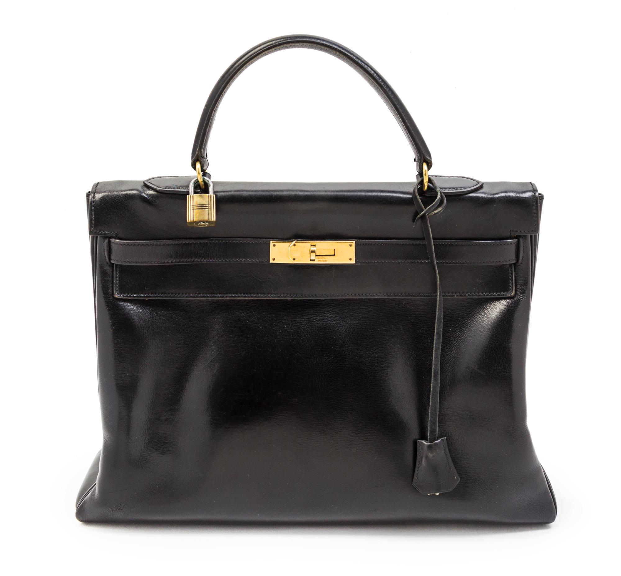 An Hermes 35cm Black Leather Kelly Bag, 13 1/2 x 9 1/2 x 5 inches.