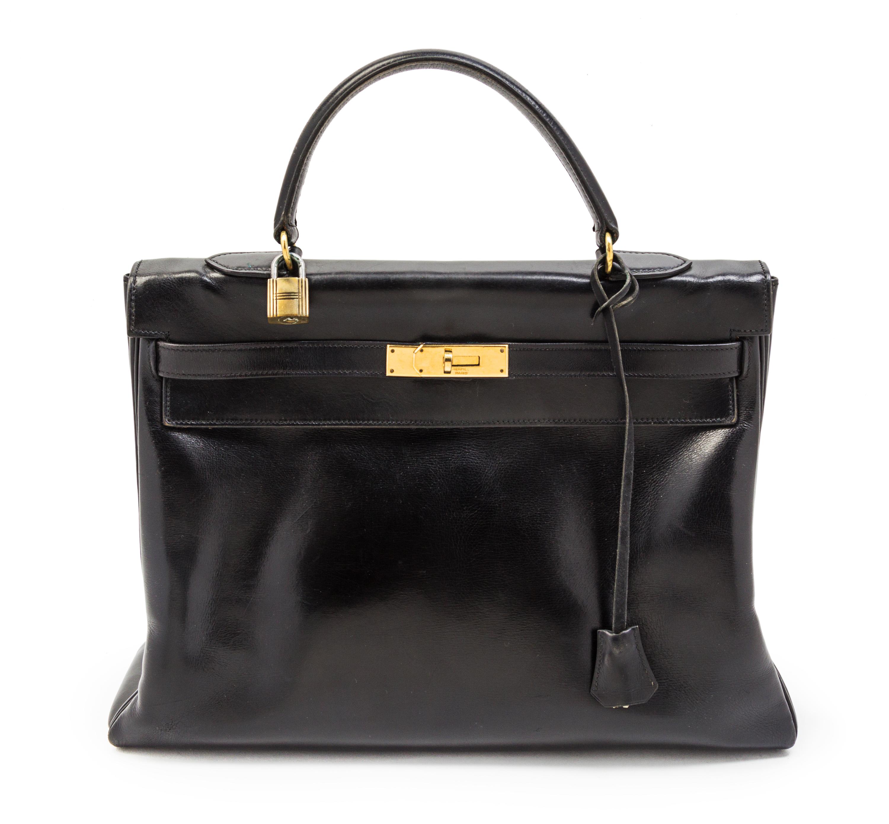 An Hermes 35cm Black Leather Kelly Bag, 13 1/2 x 9 1/2 x 5 inches.