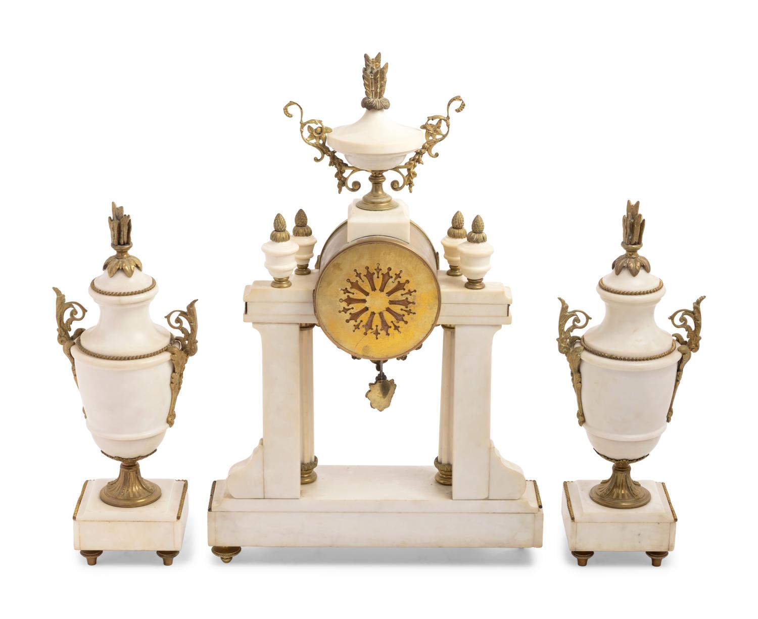 A French Gilt Metal Mounted Marble Three-Piece Clock Garniture
