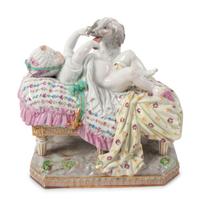 A Meissen Porcelain Figural Group of a Child in Bed with Dog