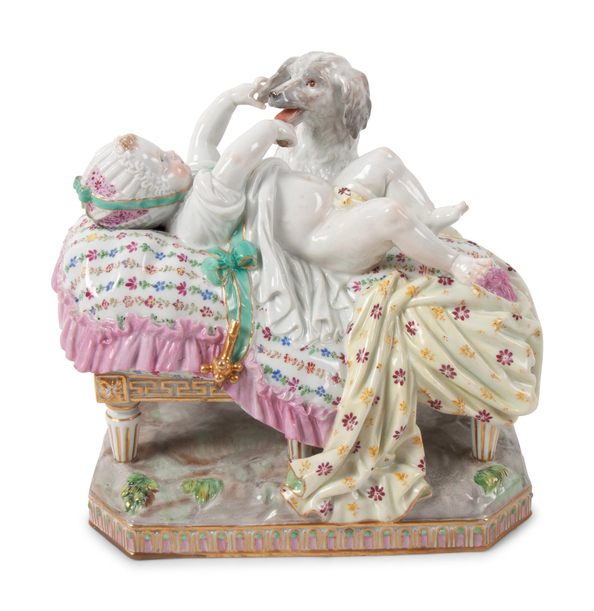 A Meissen Porcelain Figural Group of a Child in Bed with Dog
