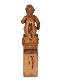 A Continental Carved Oak Figural Bracket in the Form of a Putto
