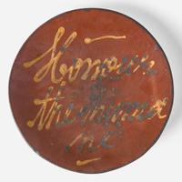 A slip-decorated and glazed redware dish 19th century