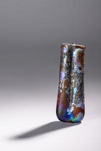 A Roman Purple Glass Double Unguentarium — .