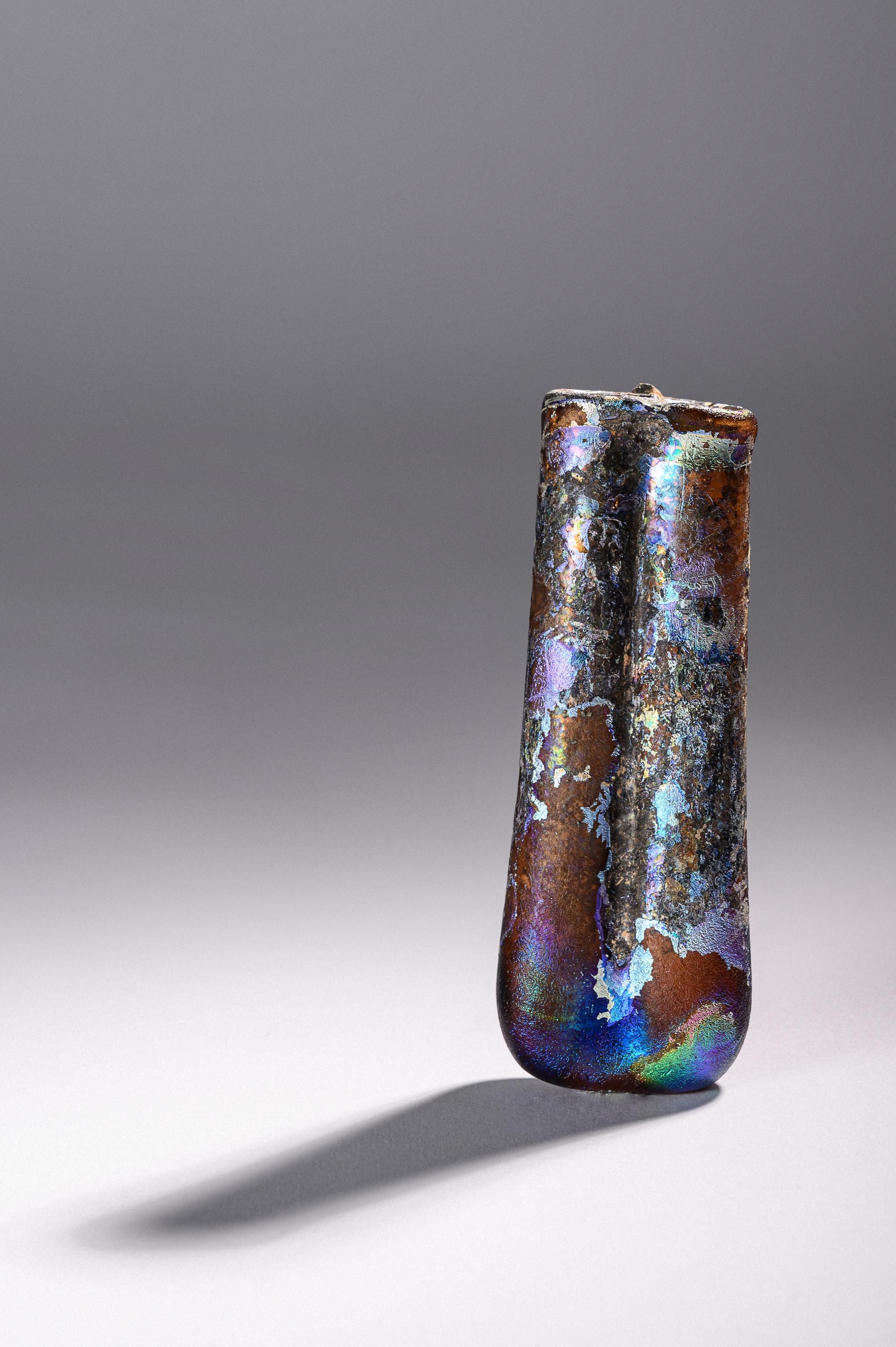 A Roman Purple Glass Double Unguentarium — .
