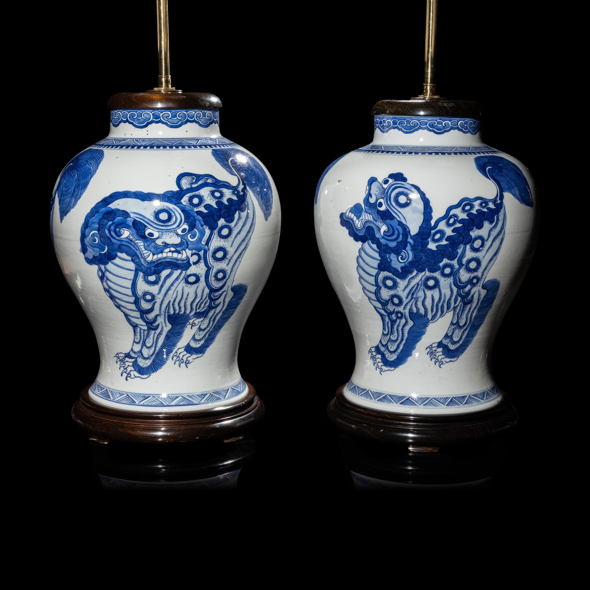 A Pair of Chinese Blue and White 'Buddhist Lion' Porcelain Jars, Kangxi Period or Later 清康熙或更晚 青花佛獅紋罐一對