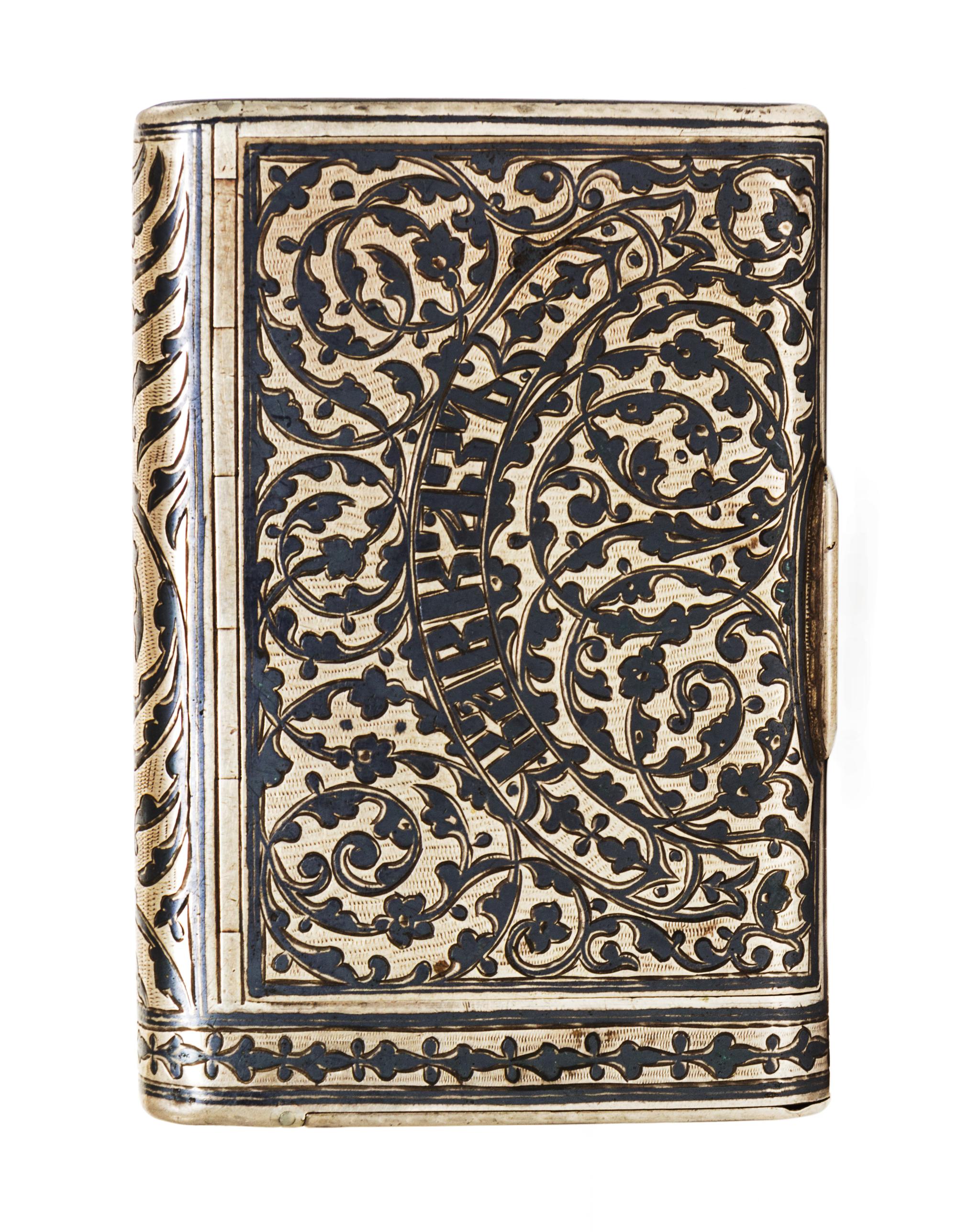 A Russian Niello Silver Cigarette Case, Moicye or Maxim Ivanov, 1896-1908, of rectangular form, the lid centered with Cyrillic script o