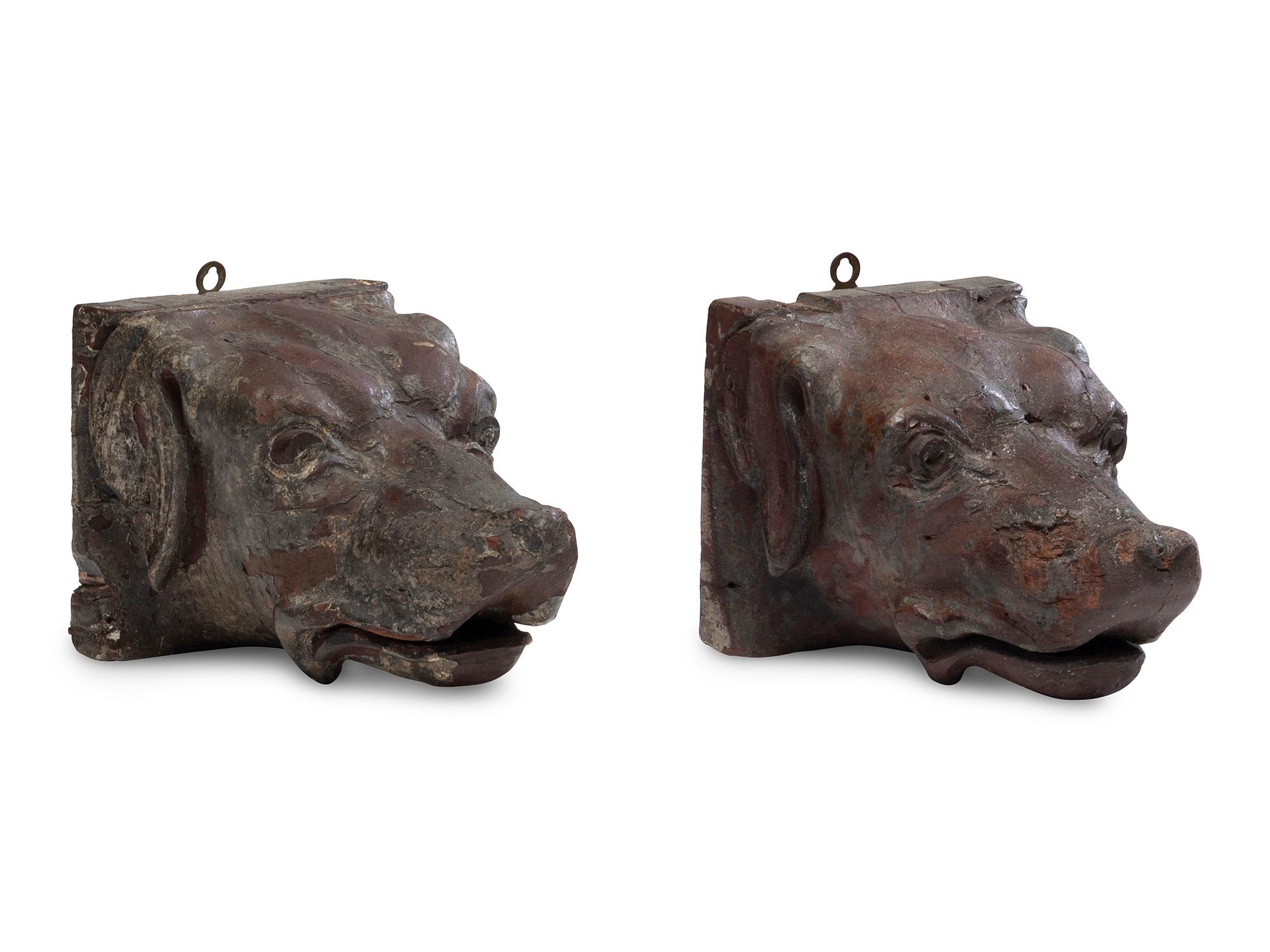 A Pair of Carved Walnut Dog-Form Wall Mounts