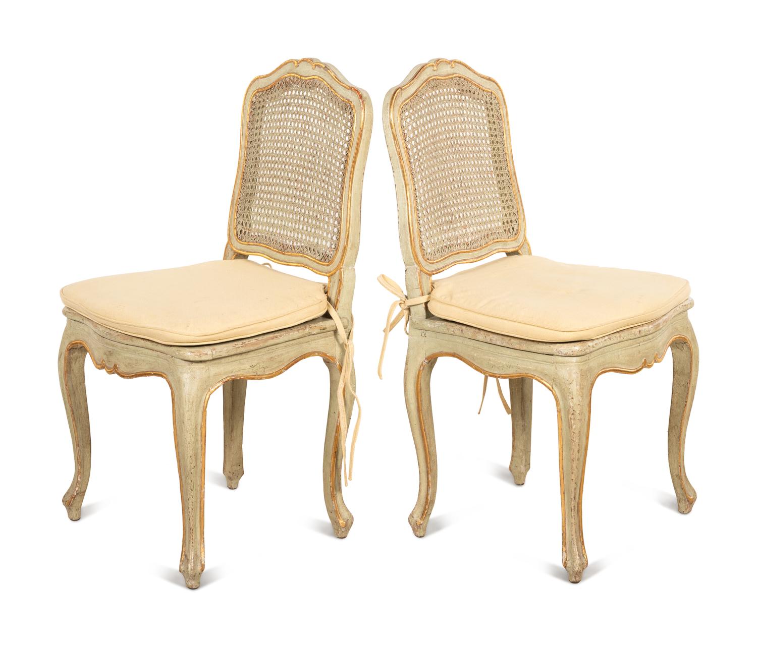 A Set of Four Louis XV Style Painted and Parcel Gilt Dining Chairs