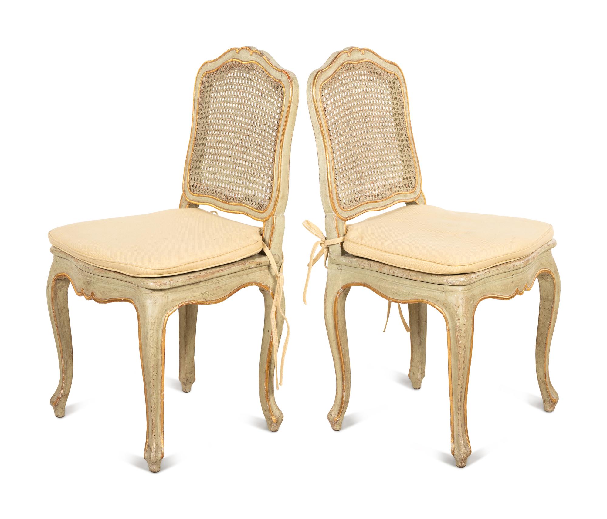 A Set of Four Louis XV Style Painted and Parcel Gilt Dining Chairs