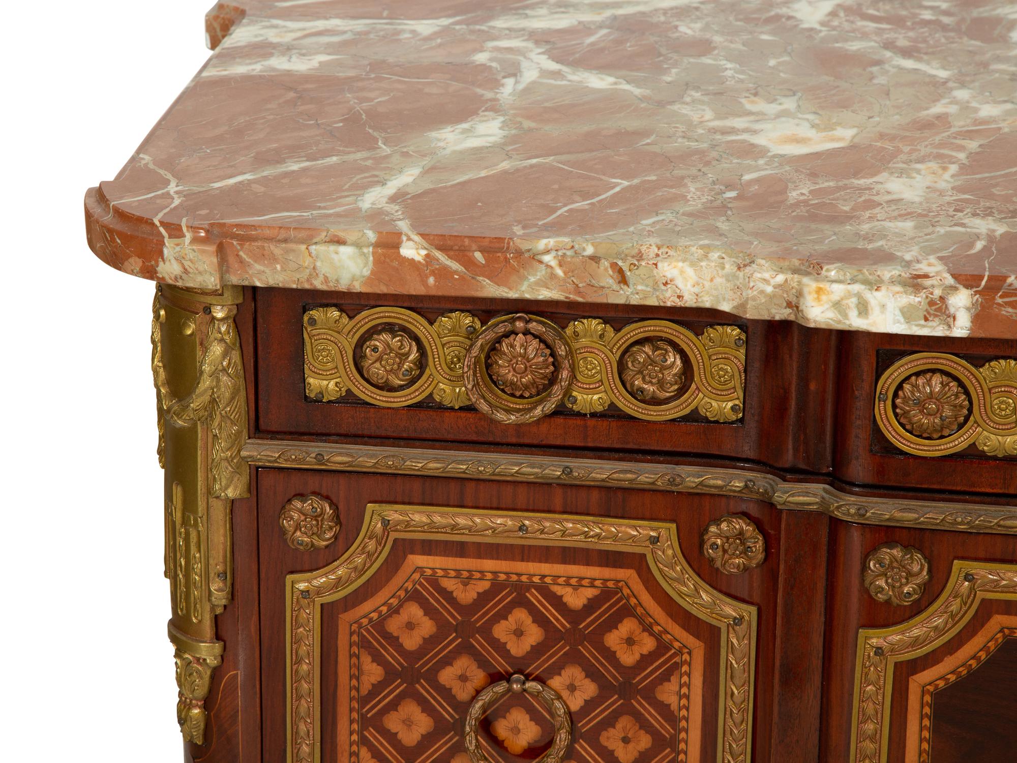 A Louis XV/XVI Transitional Style Gilt Metal Mounted Marquetry Marble-Top Commode