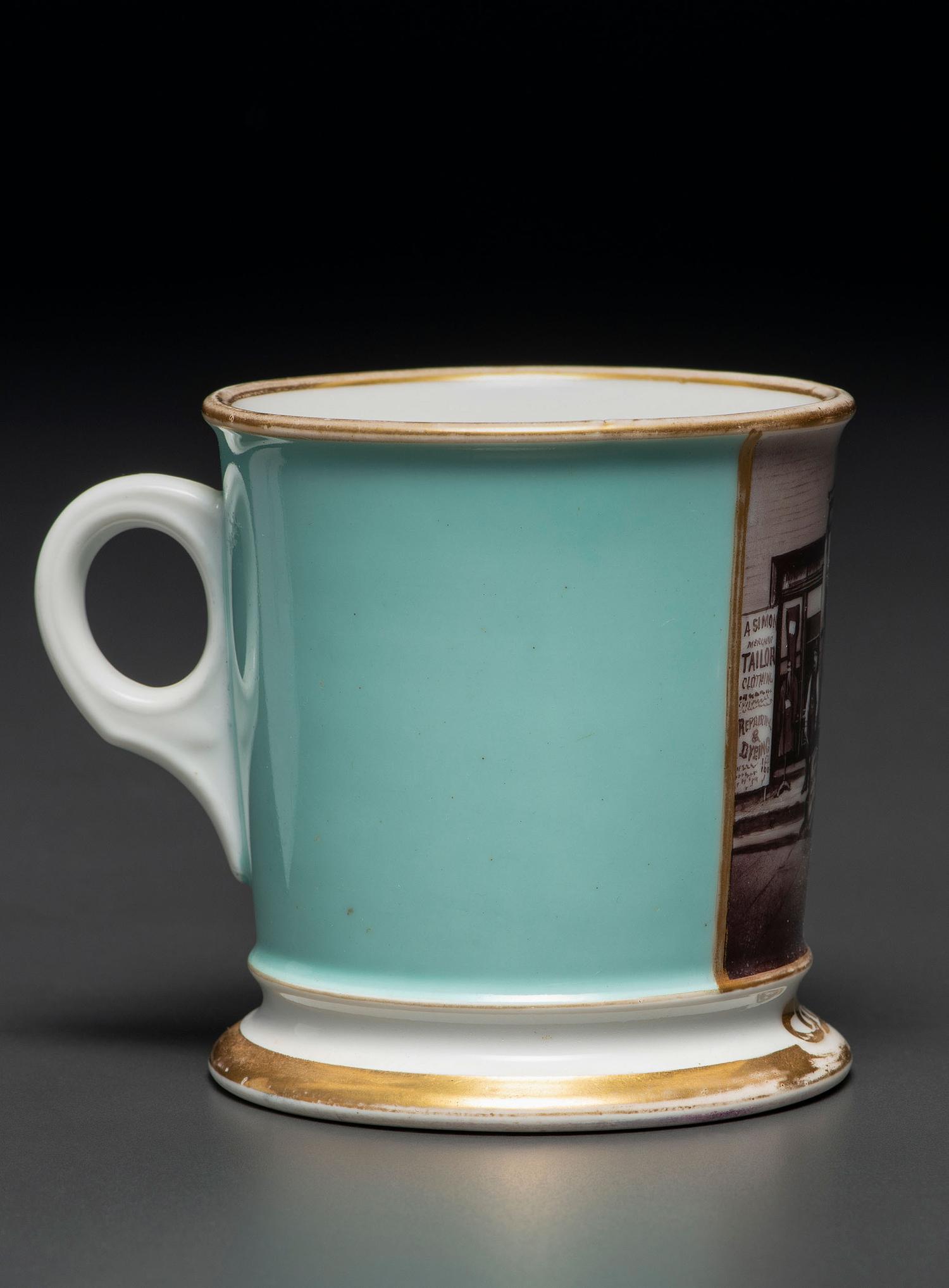 A Paint Enhanced Photographic Transfer Porcelain Occupational Shaving Mug Depicting a Tailor's Shop
