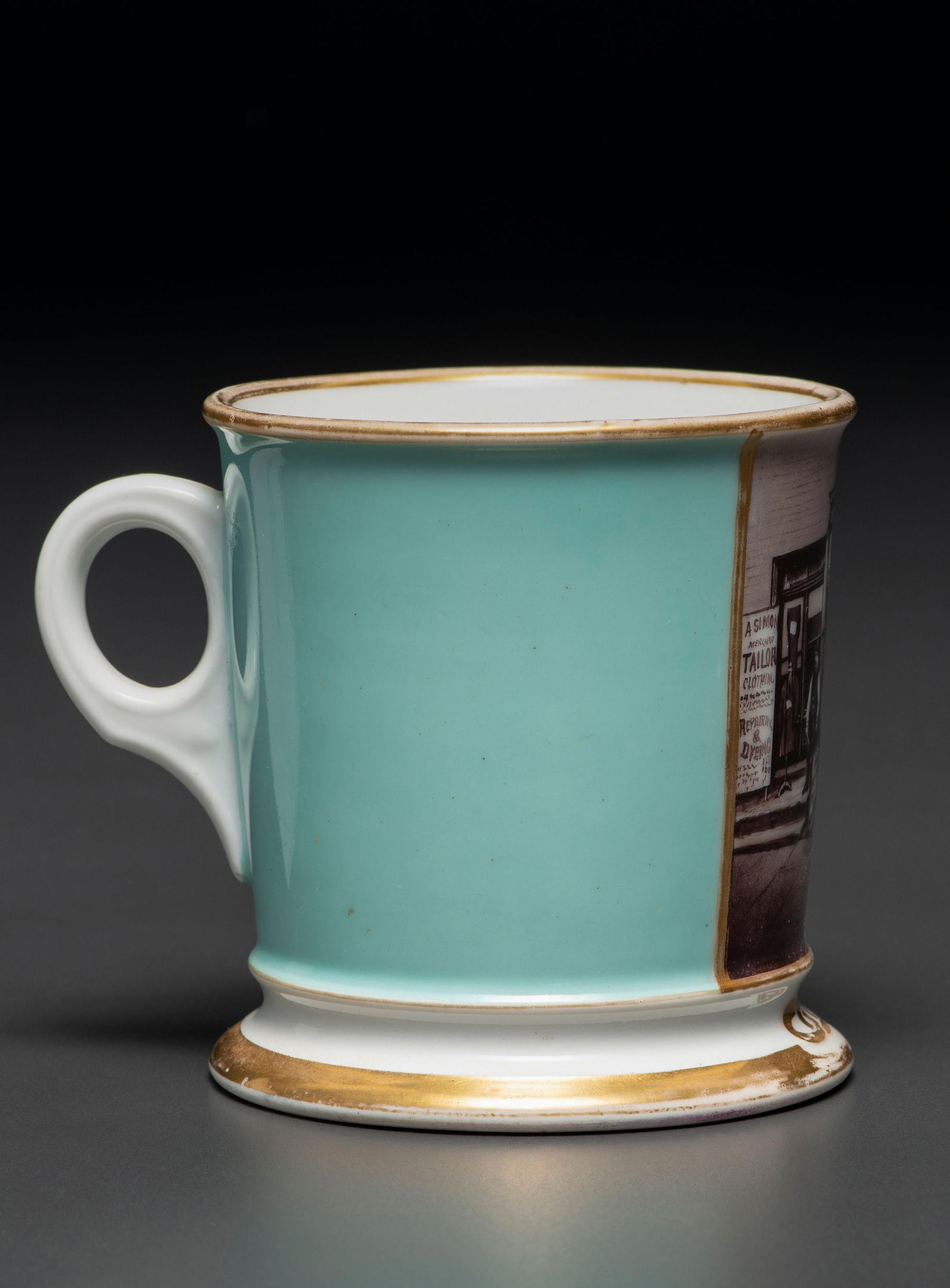 A Paint Enhanced Photographic Transfer Porcelain Occupational Shaving Mug Depicting a Tailor's Shop