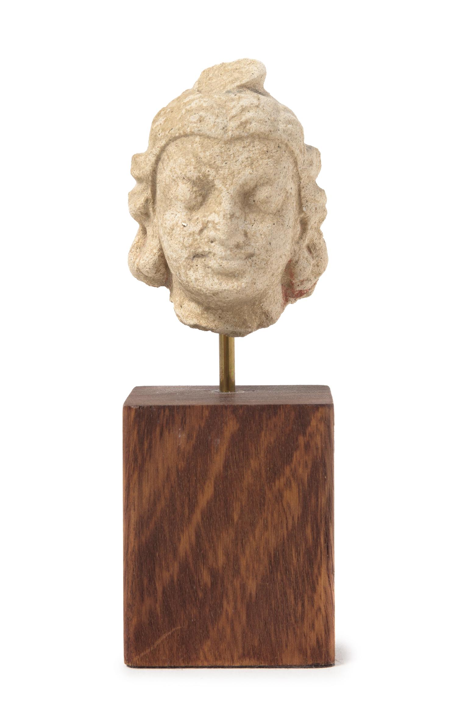 A Gandharan Stucco Head of a Warrior Height 2 inches.