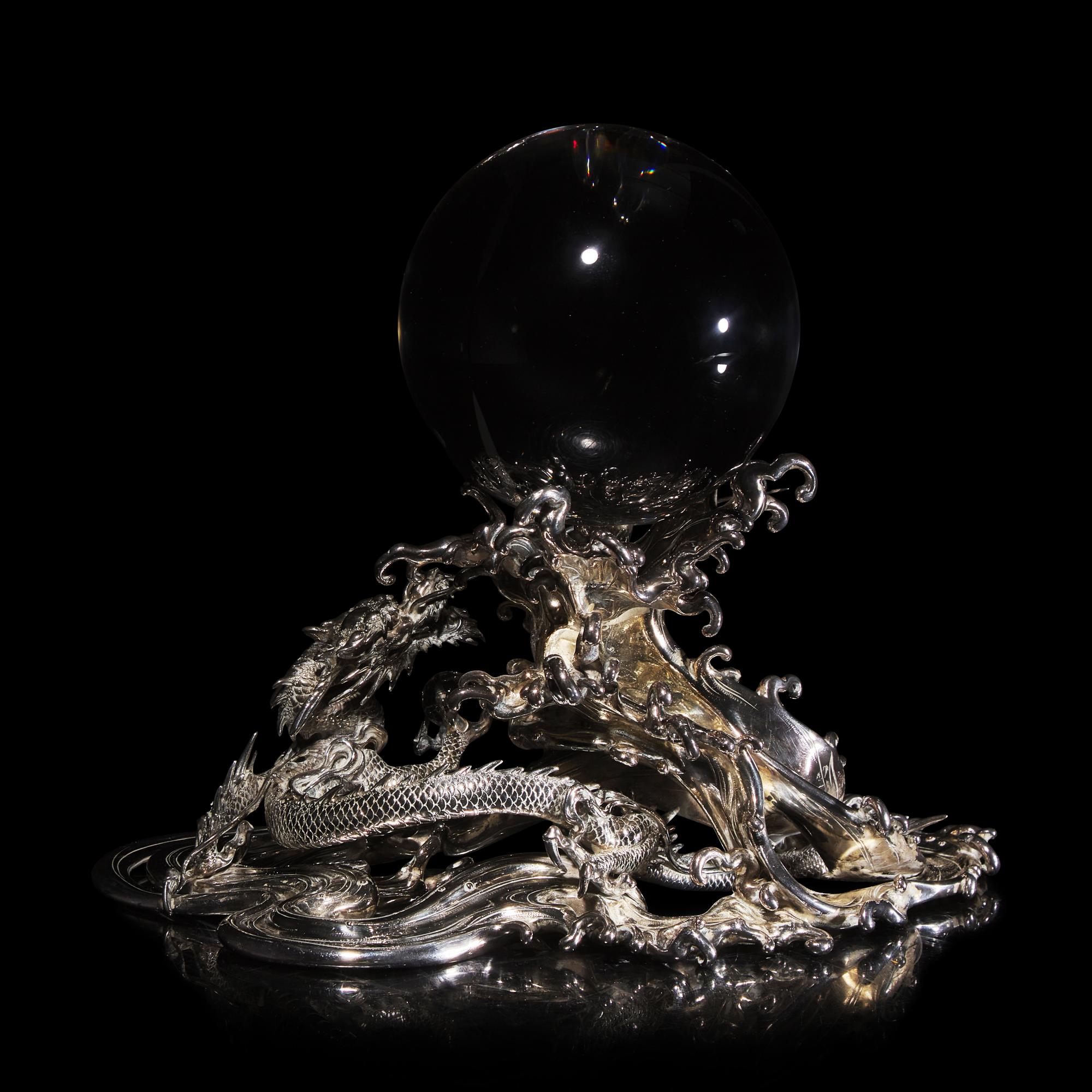 A Japanese Rock Crystal Sphere and Silver 'Dragon and Waves' Stand, Signed Yoshimasa Saku Meiji/Taisho Period 日本明治/大正時期 義正作潮を支配する珠と龍