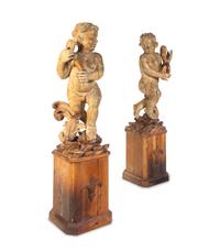 A Pair of Florentine Carved Walnut Figures of Putti on Plinths