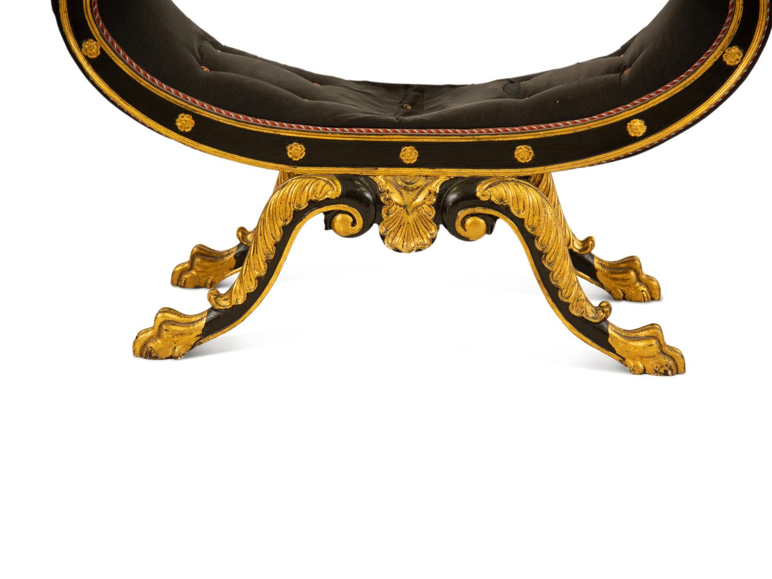 A Regency Ebonized and Parcel Gilt Curule Form Bench