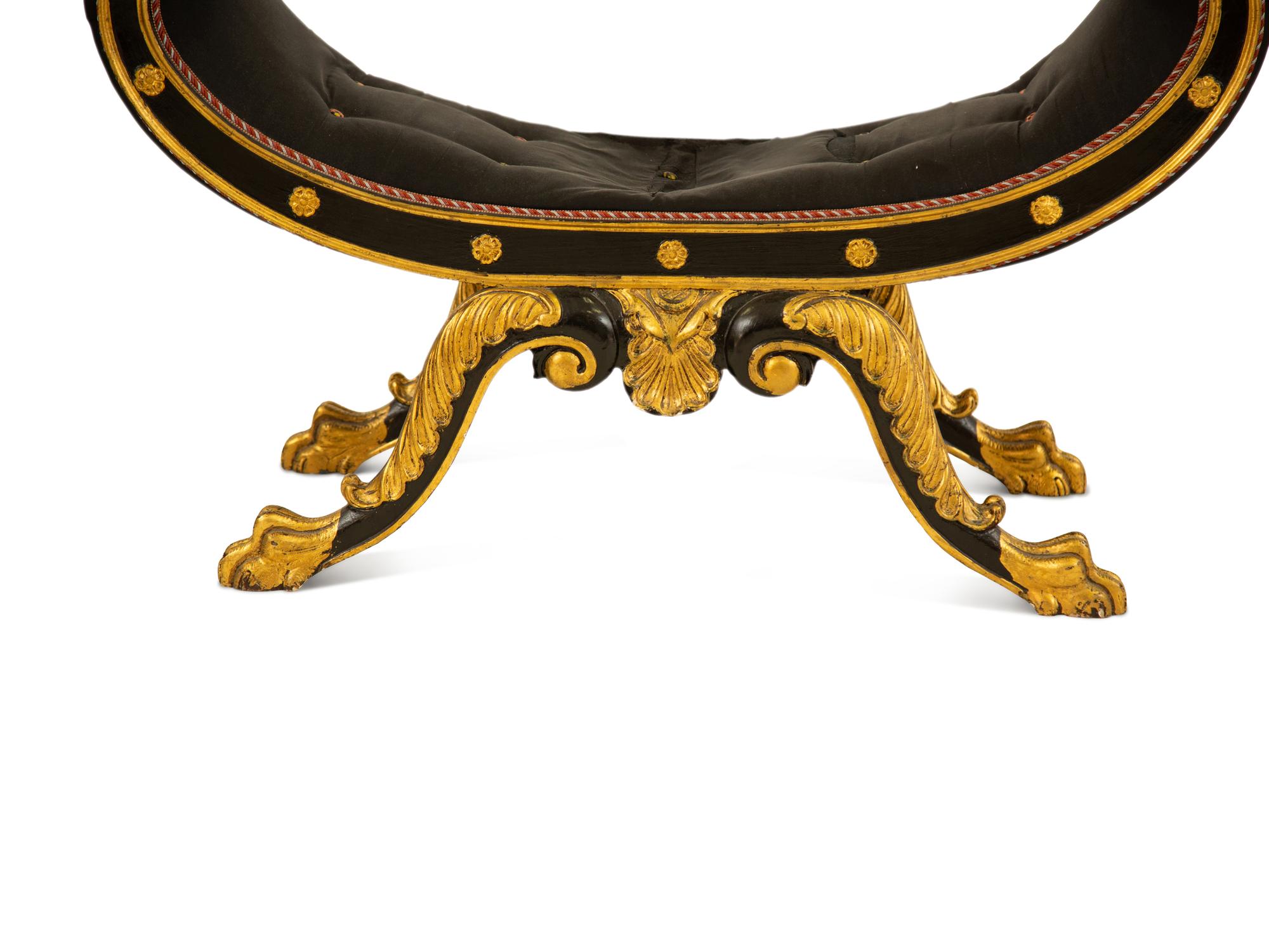 A Regency Ebonized and Parcel Gilt Curule Form Bench