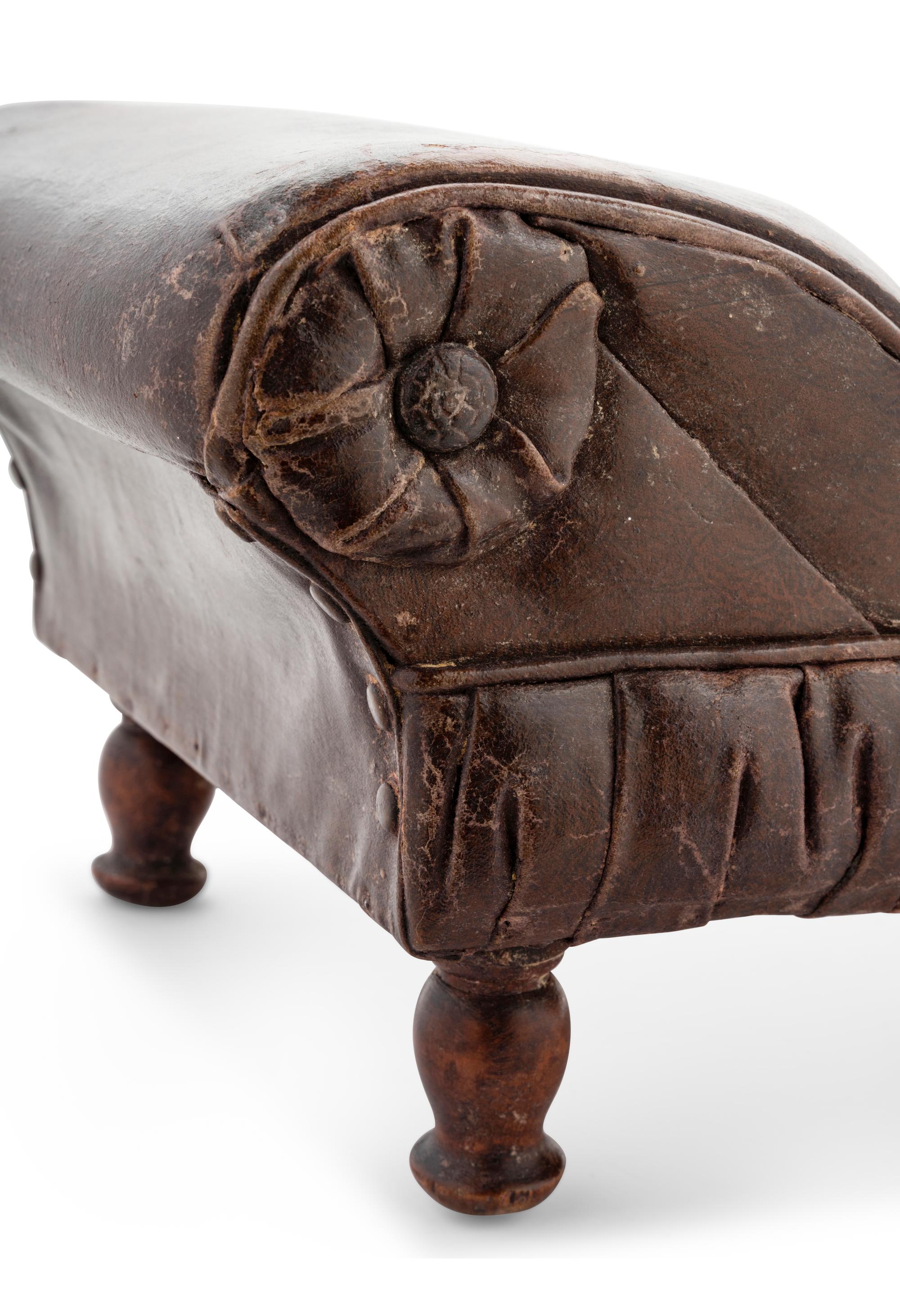 A Victorian Diminutive Leather Upholstered Chaise Longue