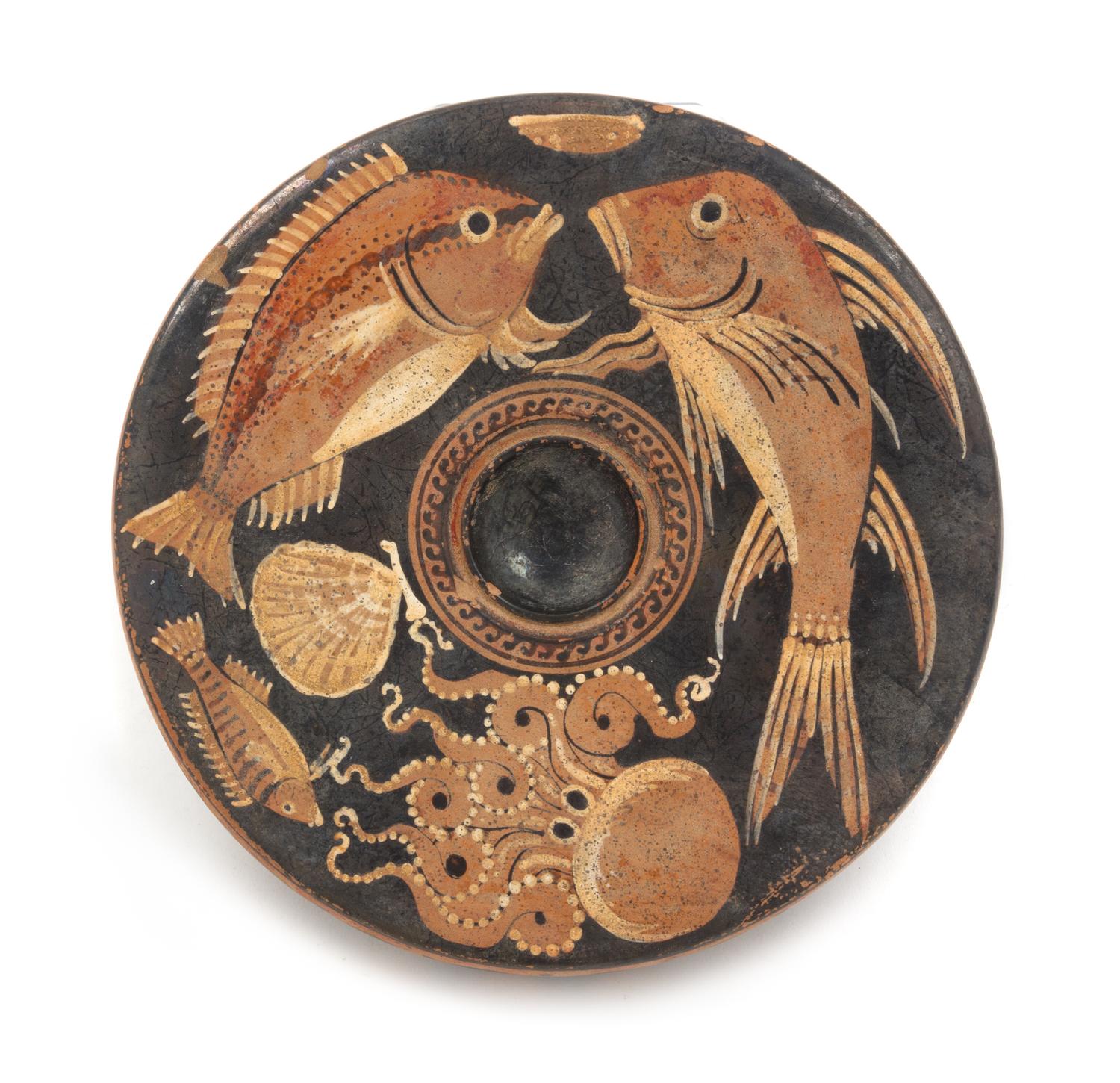 An Apulian Terra Cotta Fish Plate Height 1 3/4 x diameter 8 1/2 inches. — CIRCA 300 B.C.E.