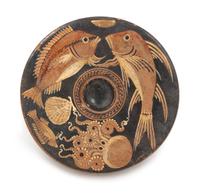 An Apulian Terra Cotta Fish Plate Height 1 3/4 x diameter 8 1/2 inches. — CIRCA 300 B.C.E.