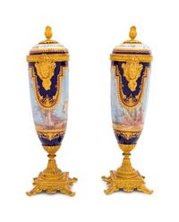 A Pair of Sèvres Style Gilt Bronze Mounted Painted, Parcel Gilt and "Jeweled" Porcelain Urns
