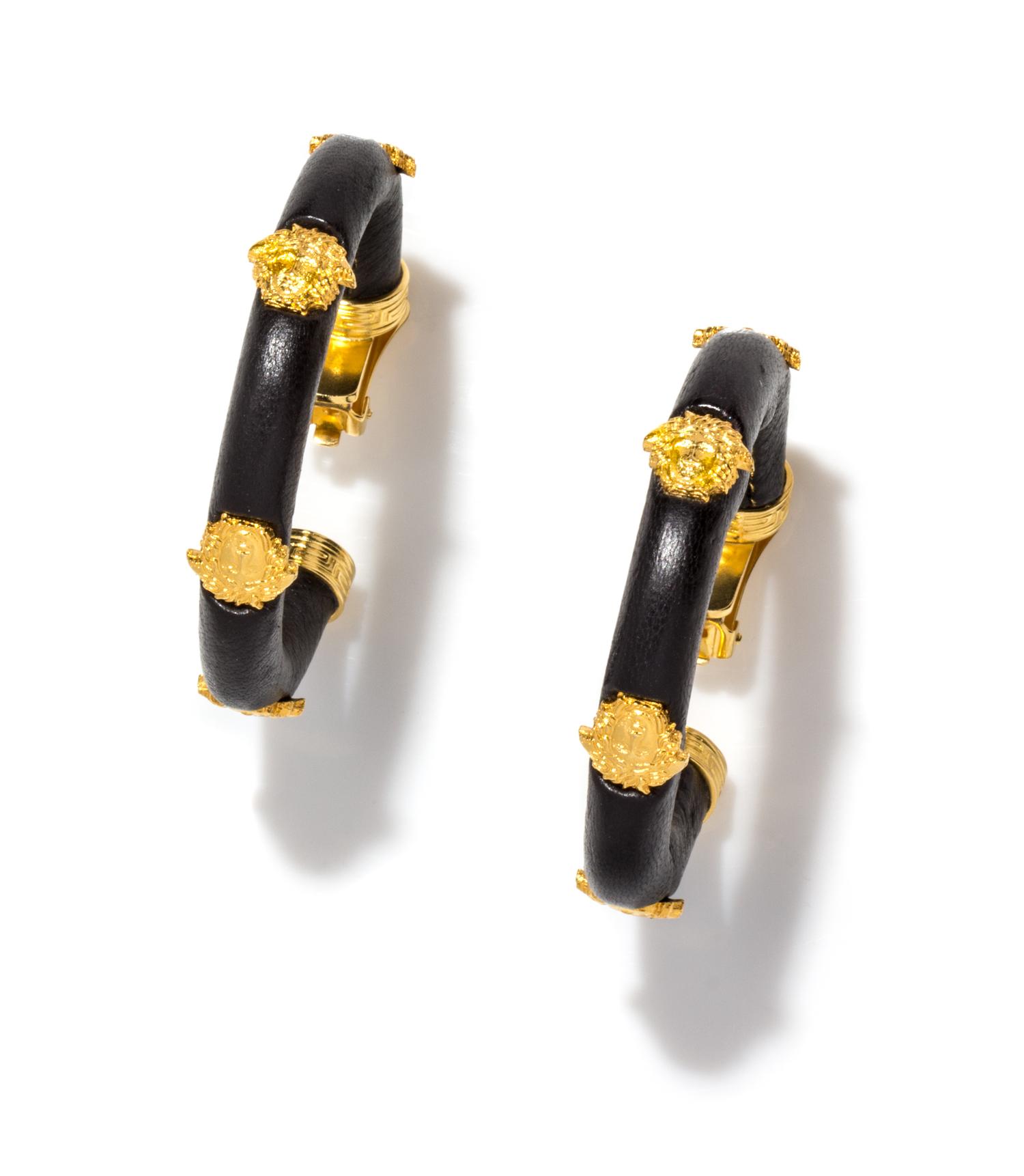 A Pair of Gianni Versace Black Leather Earclips, 4.25" diameter.