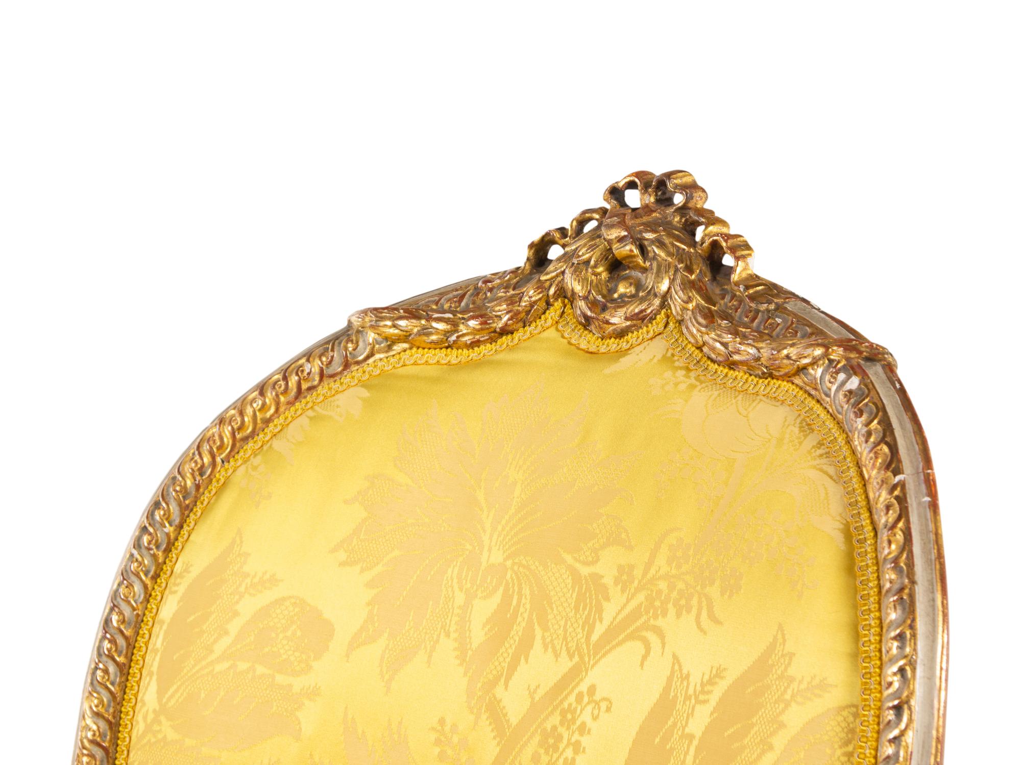 A Matched Pair of George III White-Painted and Parcel-Gilt Armchairs
