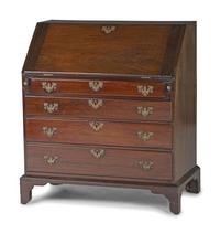 A Chippendale Figured and Shell-Carved Mahogany Slant Front Desk