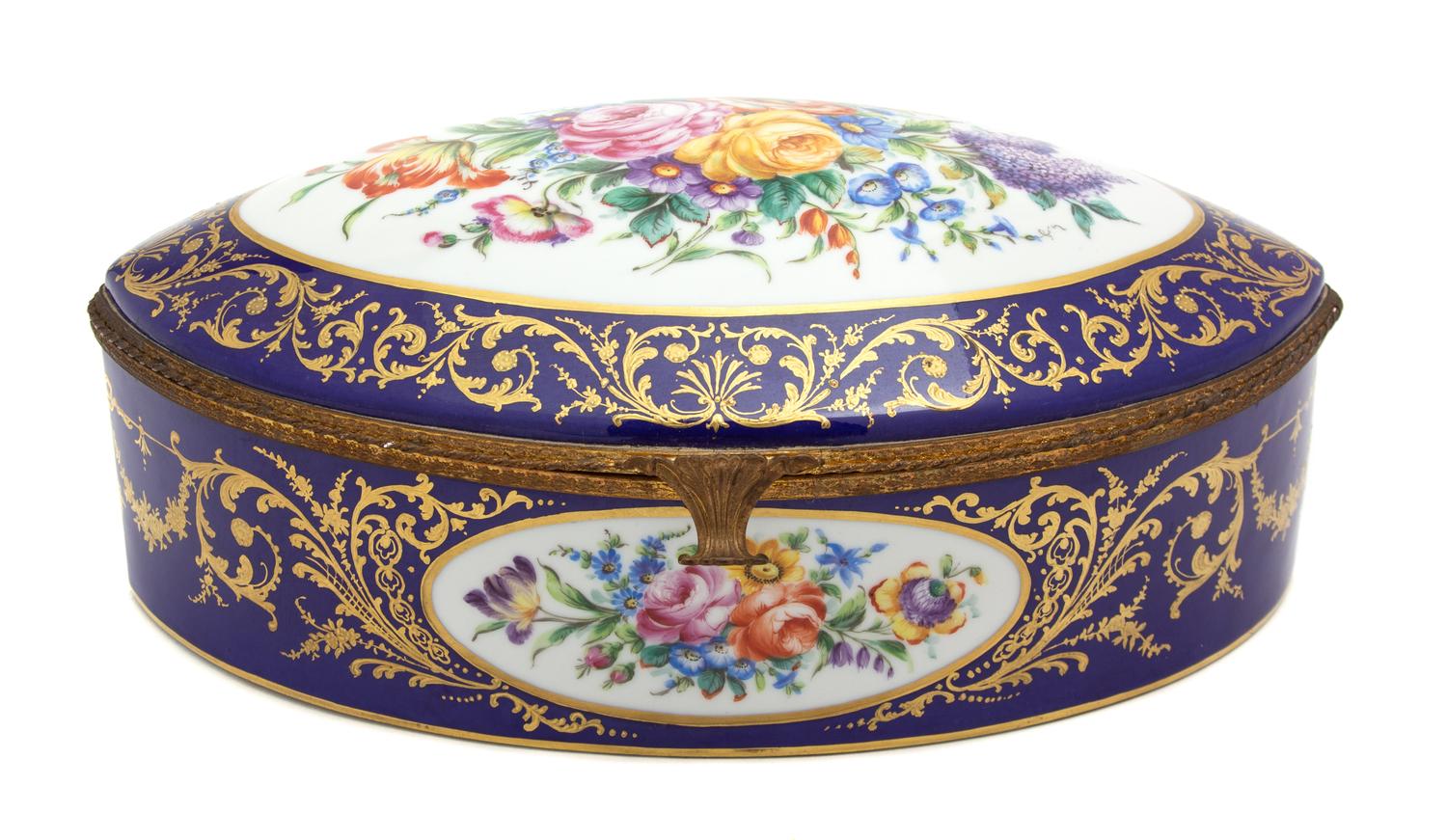 A French Hand Painted Porcelain Gilt Metal Mounted Oval Box Height 4 3/4 x width 14 x depth 10 1/4 inches. — 19TH CENTURY
