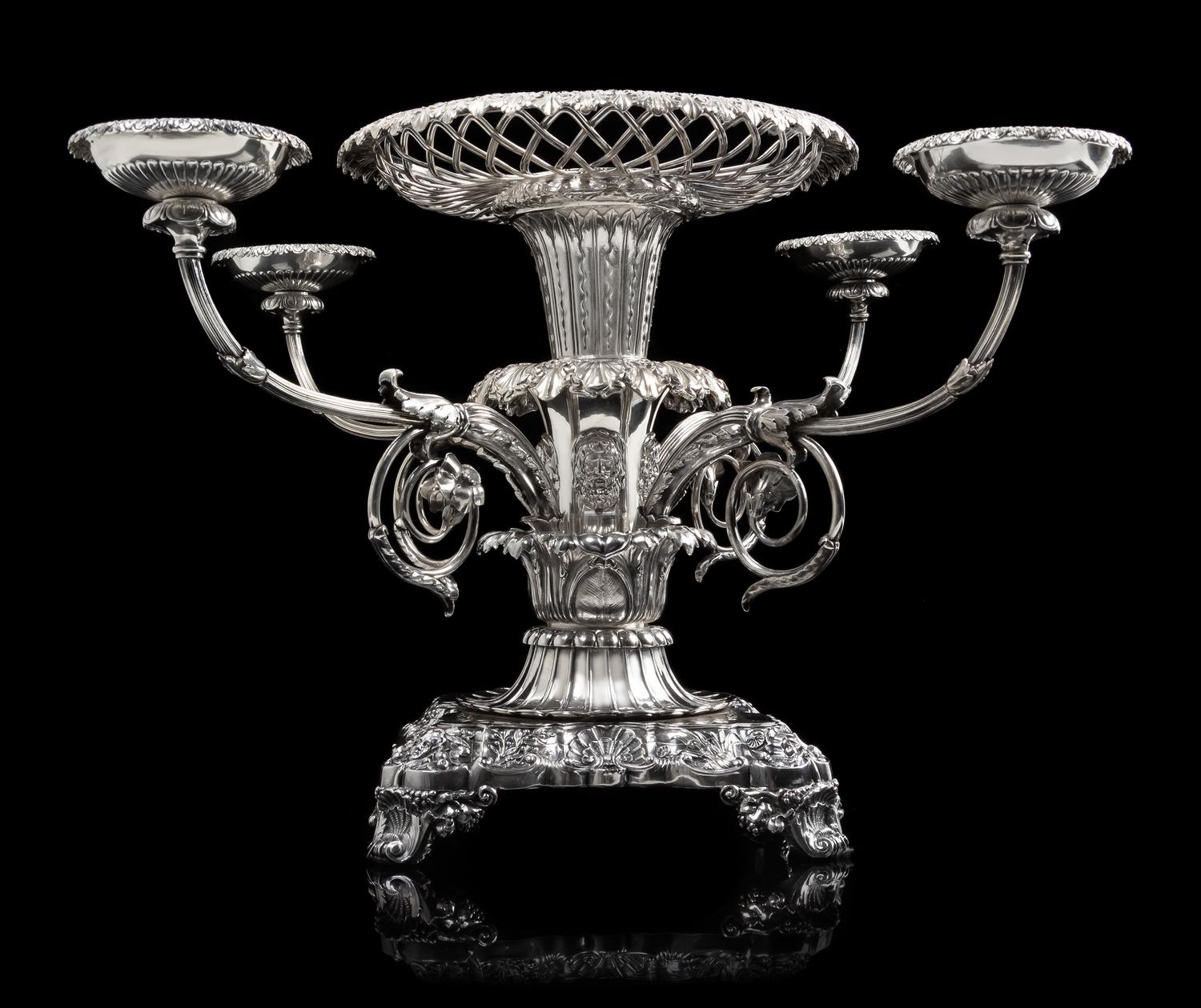A George III Silver Epergne, Paul Storr, London, 1814, the foliate rim above an openwork basket and acanthus and mask decorated stem is