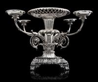 A George III Silver Epergne, Paul Storr, London, 1814, the foliate rim above an openwork basket and acanthus and mask decorated stem is