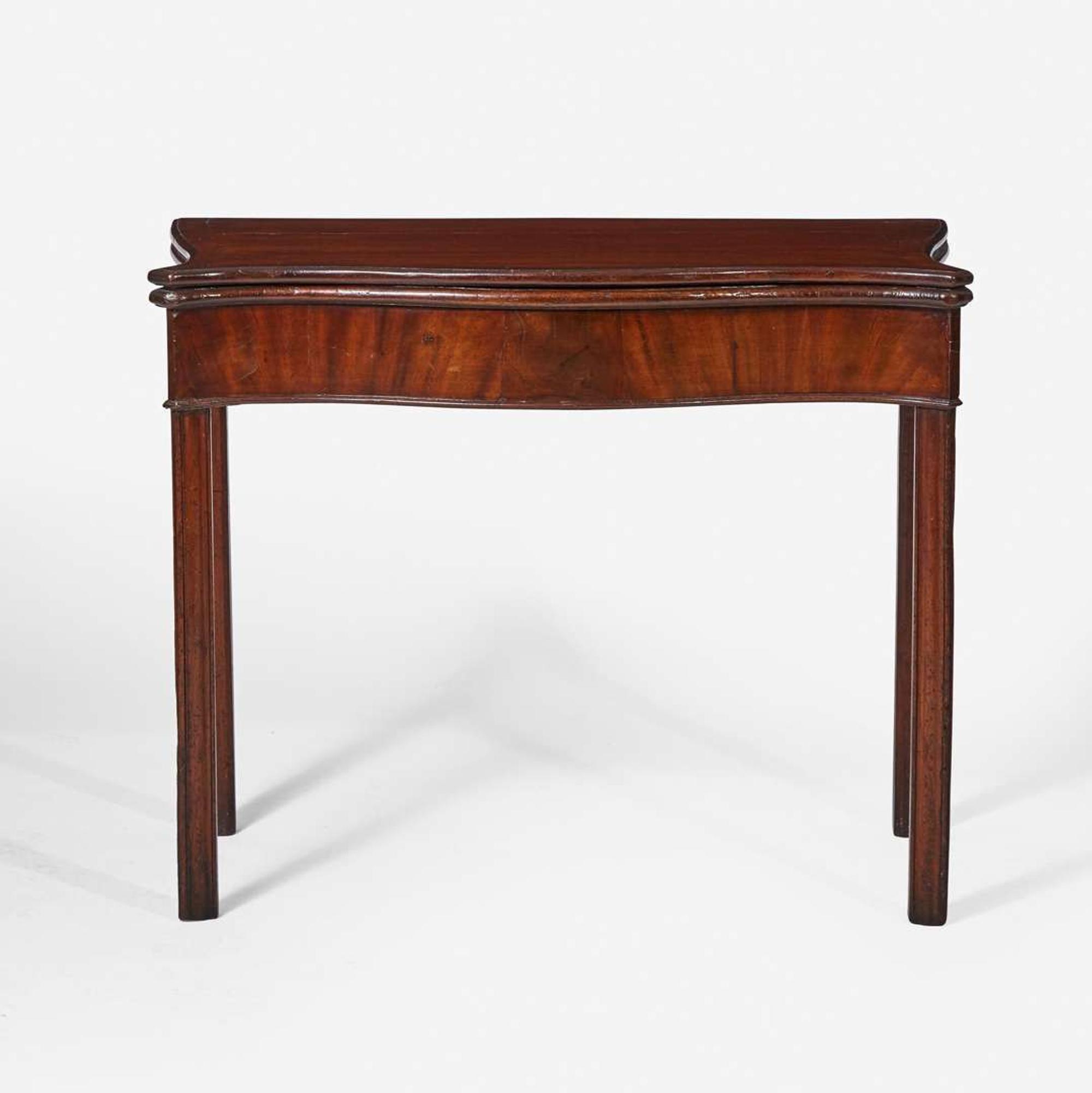 A George III serpentine carved mahogany card table circa 1770
