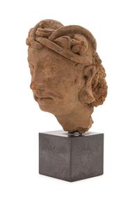 A Gandharan Terra Cotta Head of a Bodhisattva Height of head 8 inches. — HADDA REGION, 2ND CENTURY C.E.