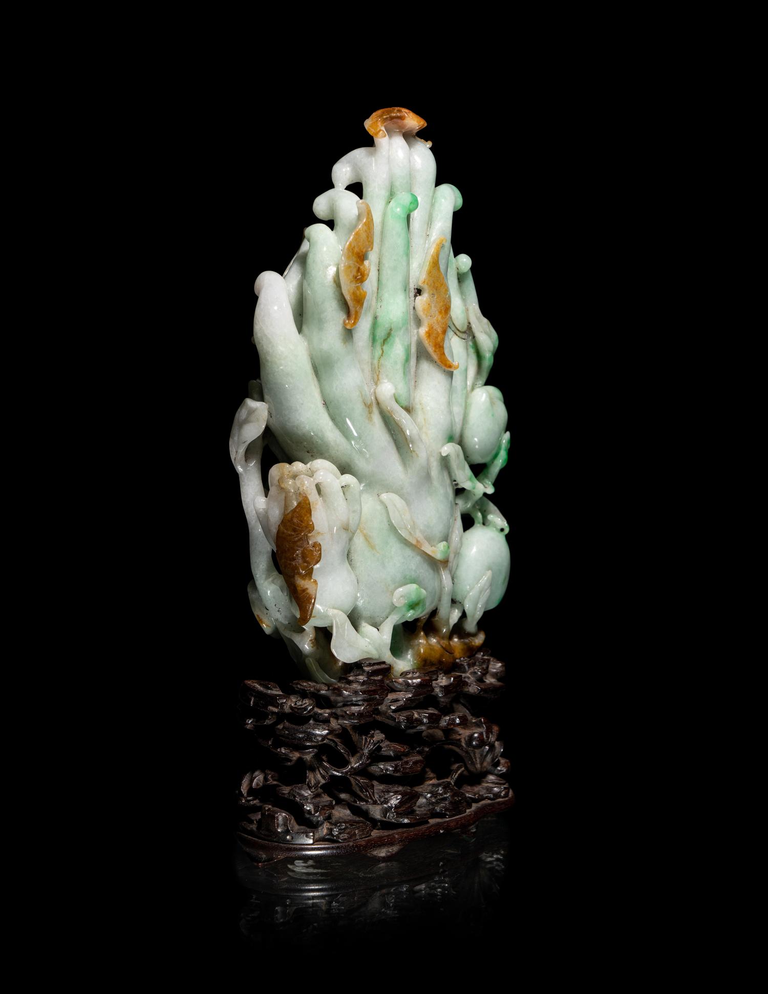 A Chinese Apple Green and Russet Jadeite Carving of Buddha's Hand Citron