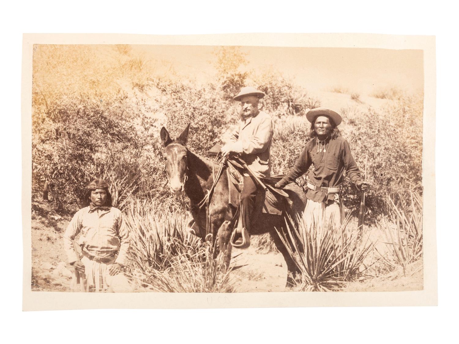 [NATIVE AMERICANS]. [BAKER & JOHNSTON, photographers]. General George Crook on muleback, with Chiricahua Apache scout Ba-Keitz-Ogie and White Mountain Apache scout Alchesay. [Colorado]: ca 1885.