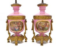 A Pair of Sevres Style Porcelain and Gilt Bronze Mounted Urns, Height of urn 13 5/8 inches.