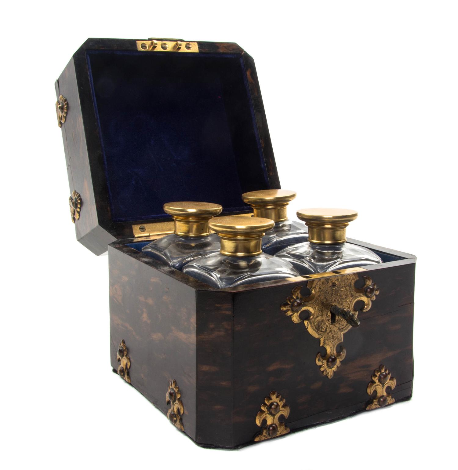 A French Brass and Porcelain Mounted Calamander Decanter Set, SECOND HALF 19TH CENTURY, Height 5 3/8 x width 5 3/4 inches. — SECOND HALF 19TH CENTURY,