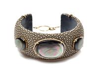 A 14 Karat Yellow Gold, Shagreen, Diamond and Mother-of-Pearl Cuff Bracelet, 2.5" diameter x 1.5" width.