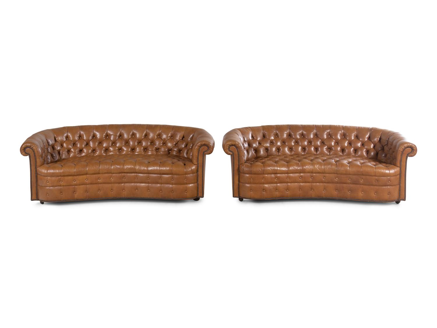 A Pair of Faux Leather Upholstered Chesterfield Sofas