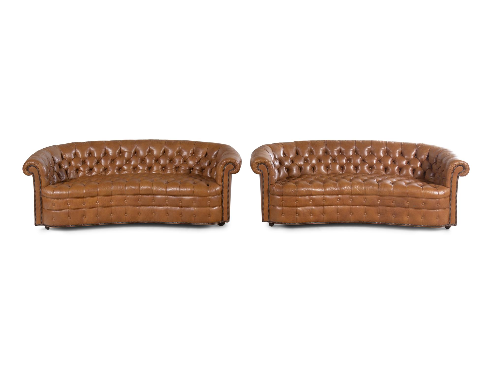 A Pair of Faux Leather Upholstered Chesterfield Sofas