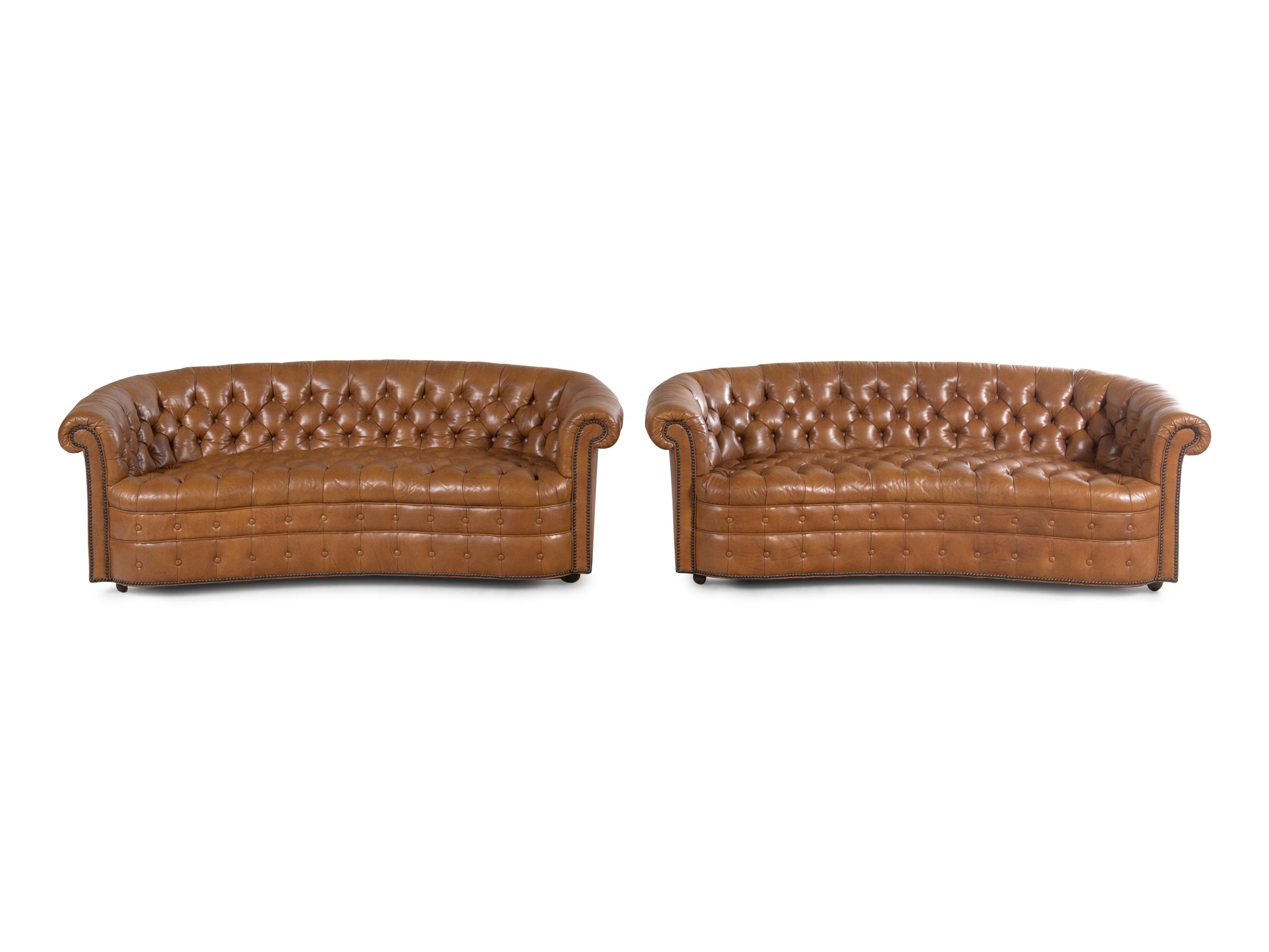 A Pair of Faux Leather Upholstered Chesterfield Sofas