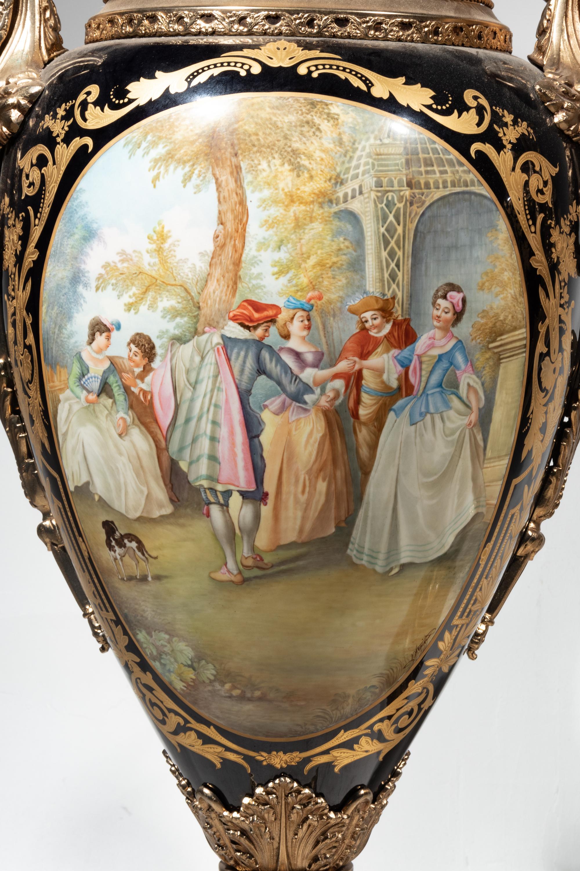 A Pair of Monumental Sèvres Style Gilt Metal Mounted Porcelain Covered Urns on Pedestals